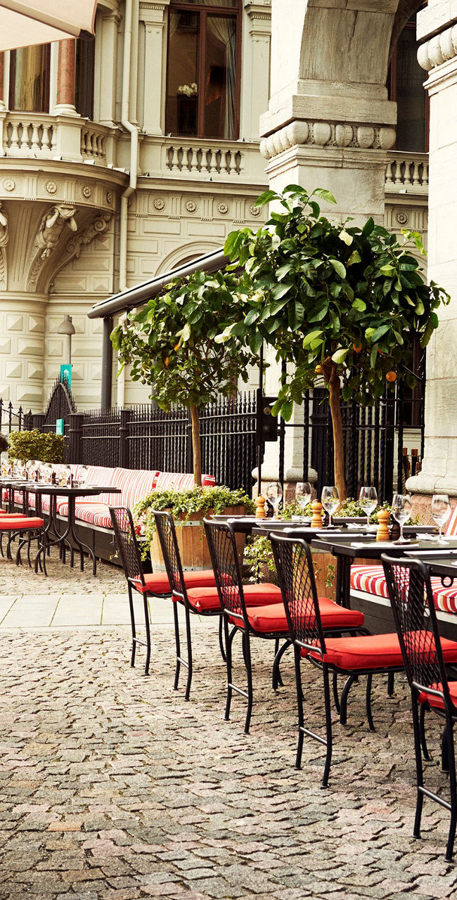 Outdoor cafe with red seating in urban setting