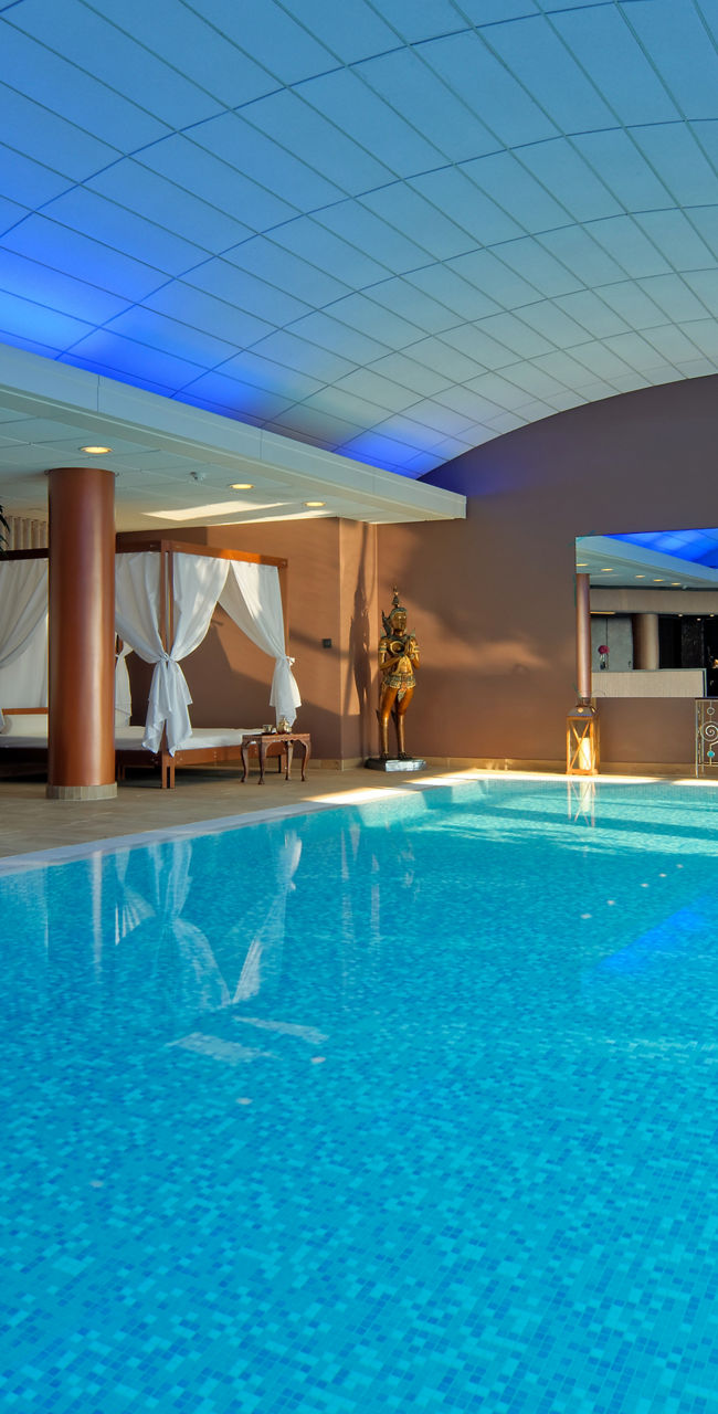 Luxury indoor pool with lounge seating