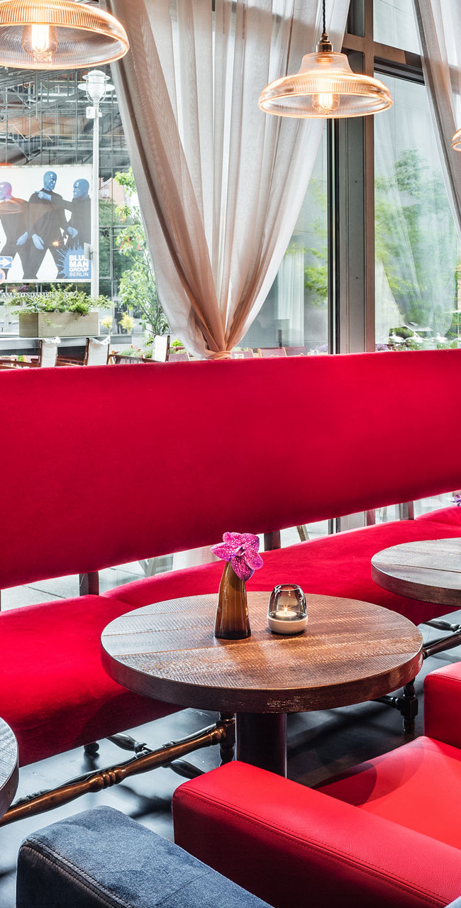 Modern lounge with red seating and large windows