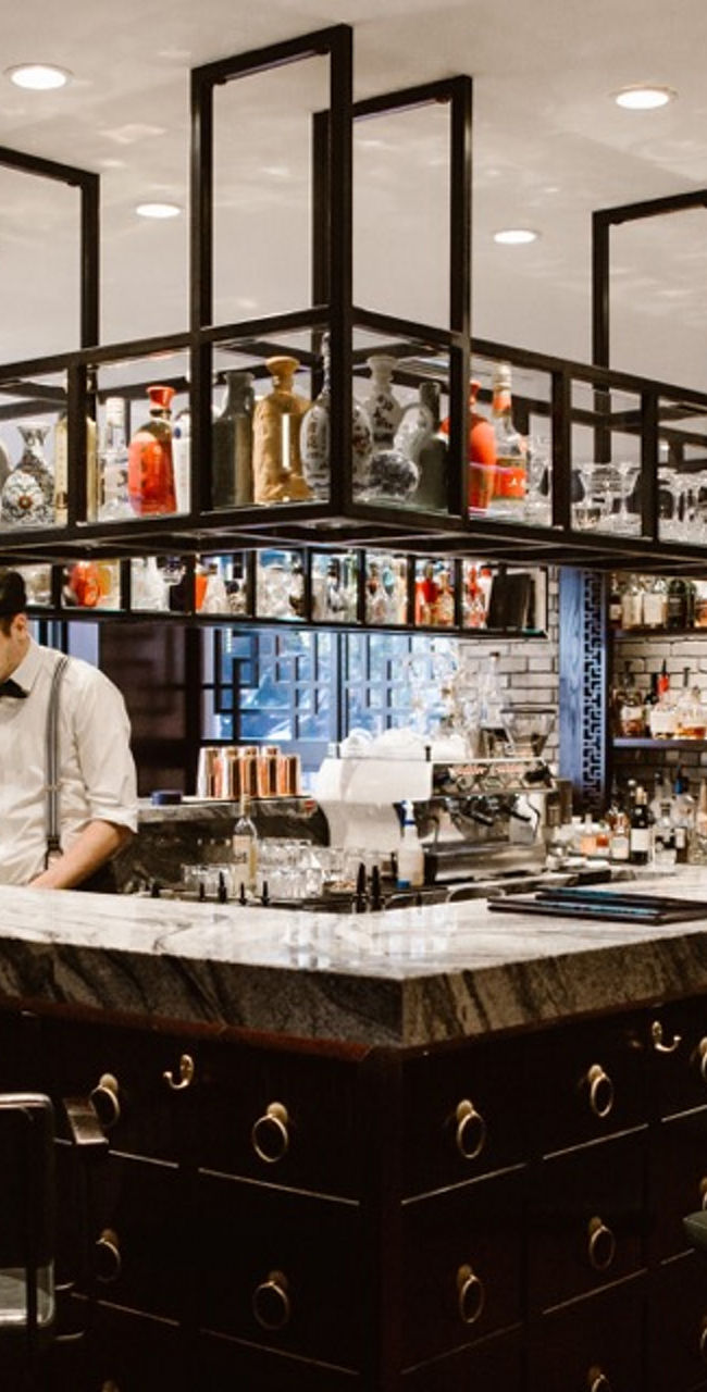 Modern bar interior with bartender working