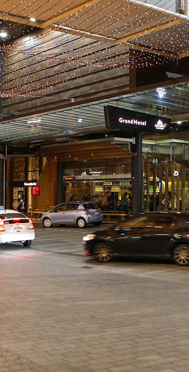 City street with illuminated hotel entrance