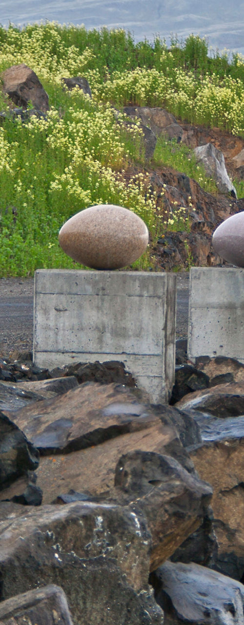 Stone sculptures along rocky shoreline