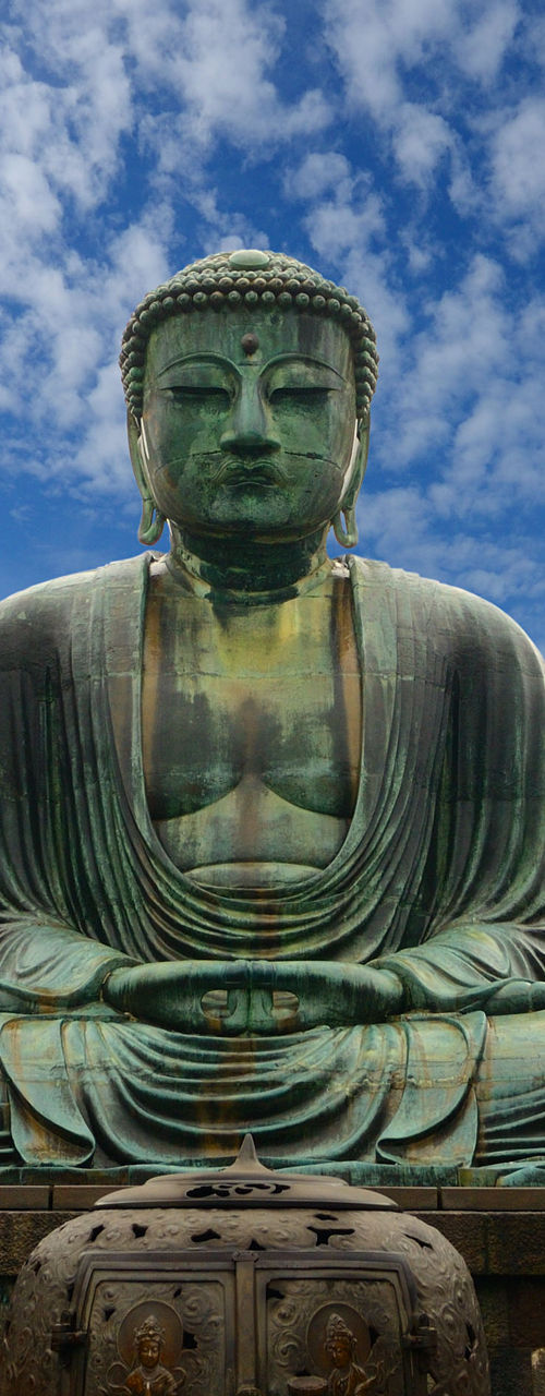 Large bronze Buddha statue in outdoor setting