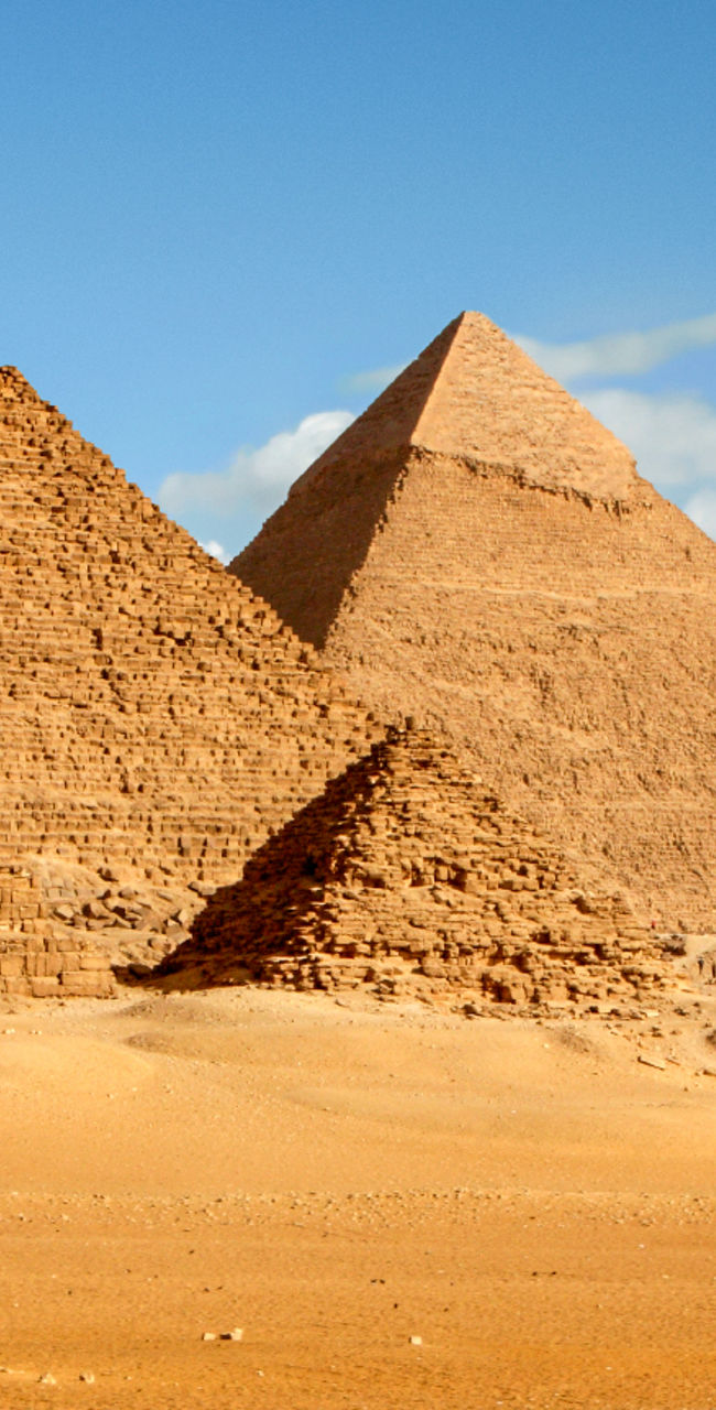 Camel riders near Egyptian pyramids