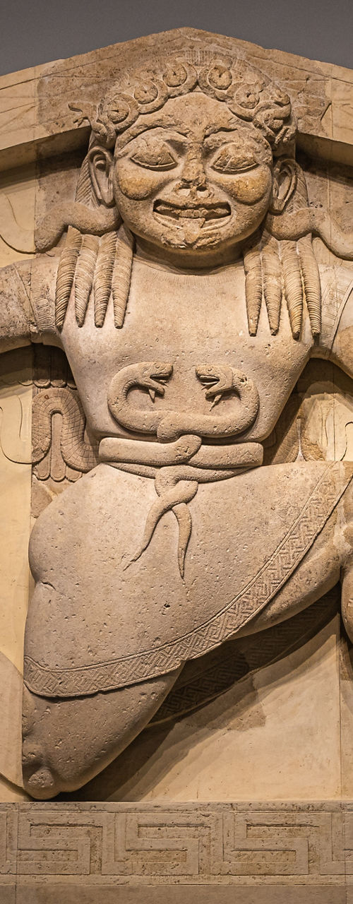 Ancient stone relief with mythical figures