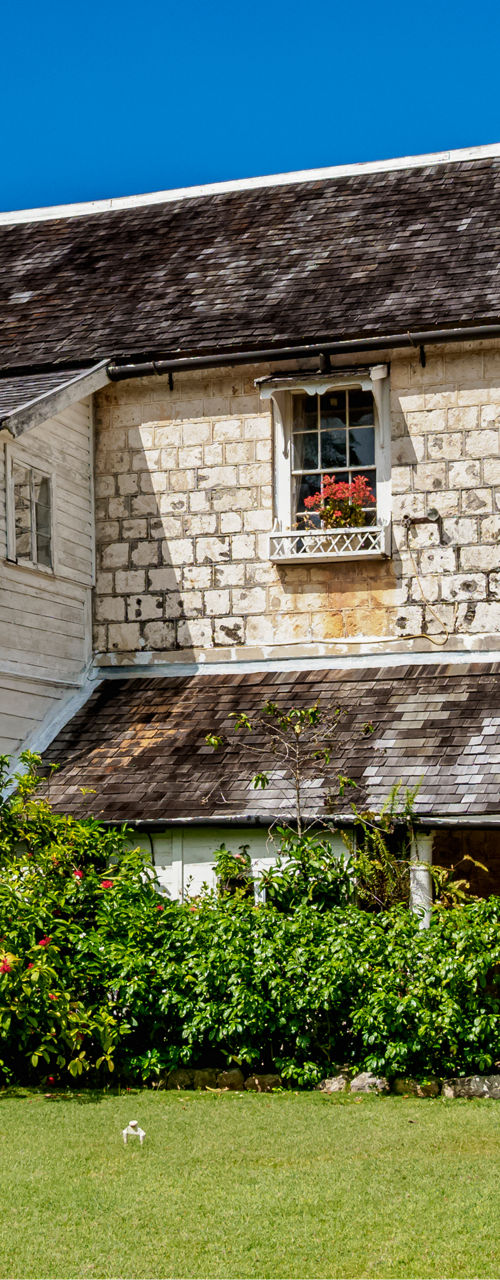 Historic stone building with lush garden