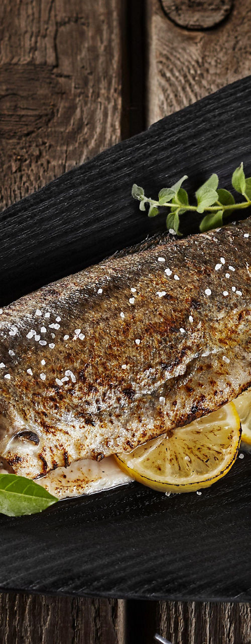Grilled fish with herbs and lemon slices