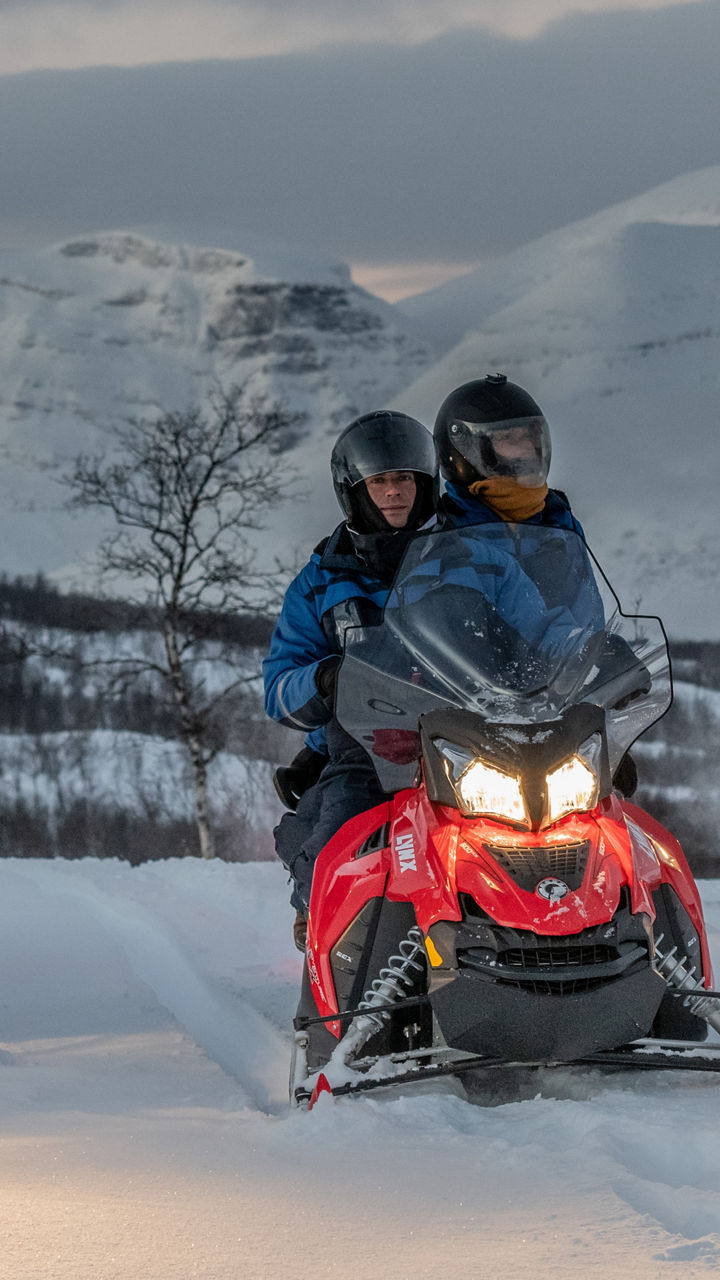 Evening Snowmobile Through Winter Landscapes