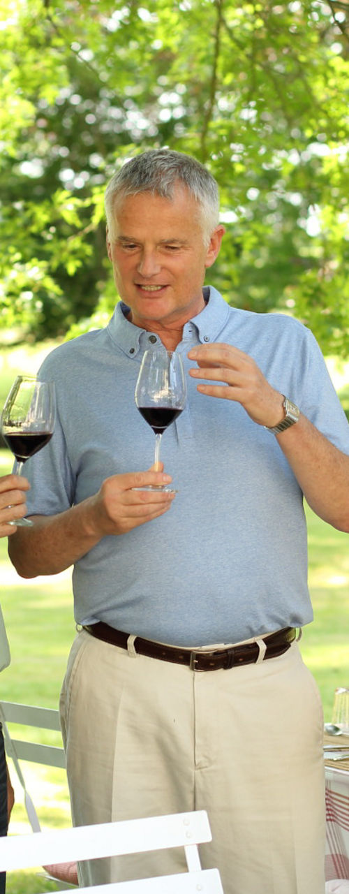 Group toasting with red wine outdoors