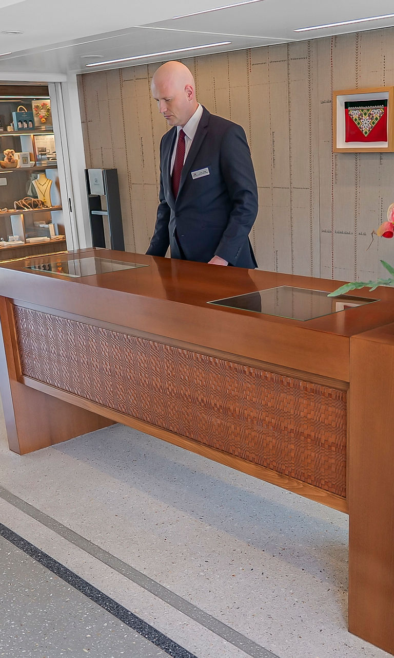 Hotel reception lobby with concierge and umbrellas