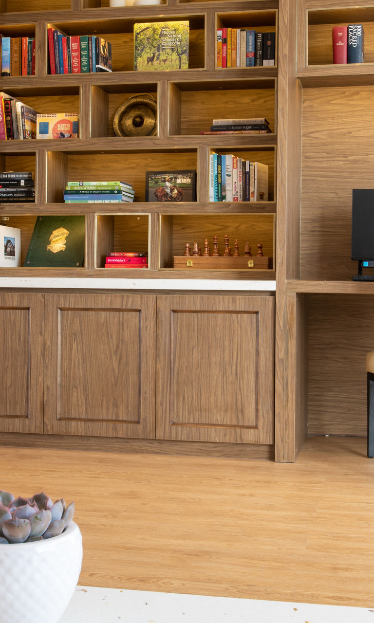 Modern lounge with wooden bookshelf and computers