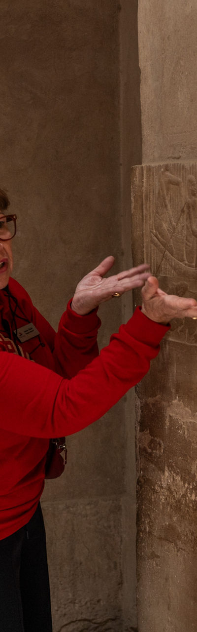 Tourists Observe Ancient Wall Carvings in Historic Site