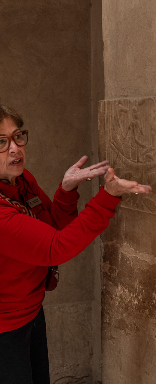 Tourists Observe Ancient Wall Carvings in Historic Site