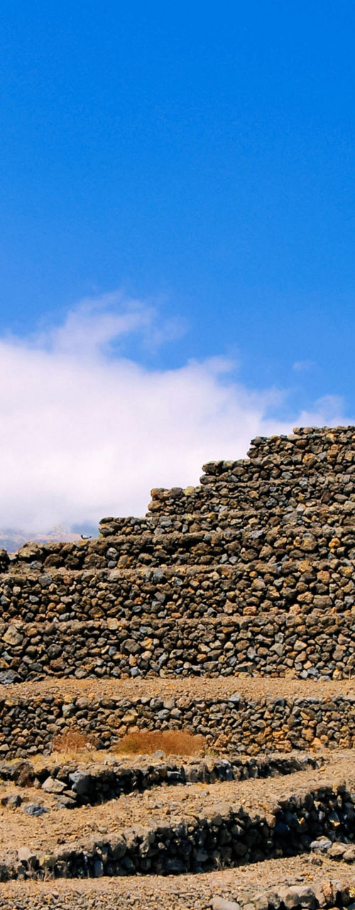 Ancient stone pyramids under blue sky