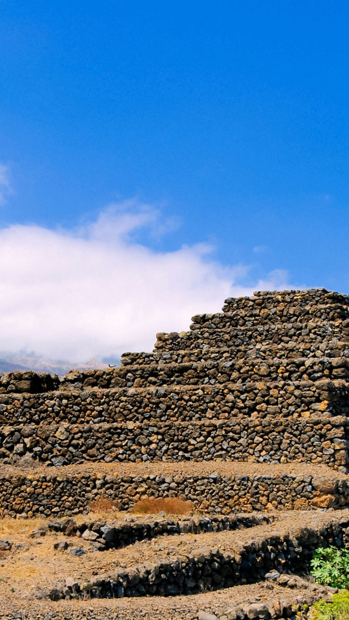 Ancient stone pyramids under blue sky