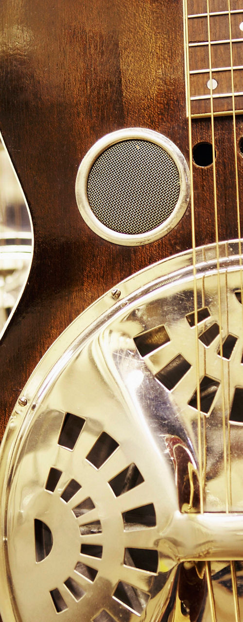 Close-up of resonator guitars in store