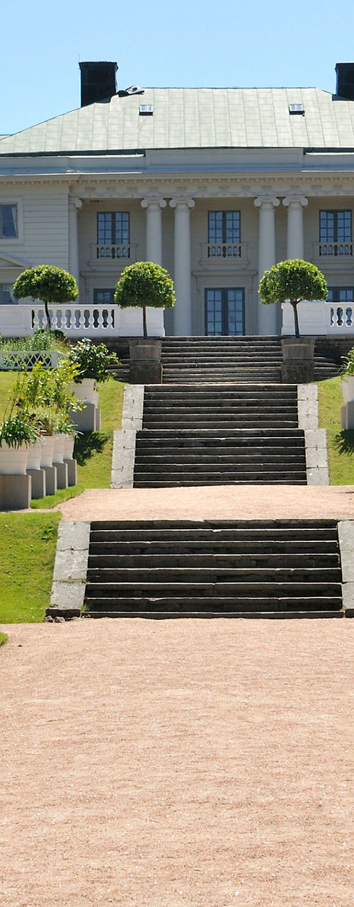 Elegant mansion with manicured garden pathway