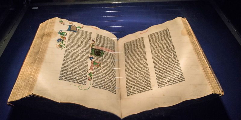 Illuminated manuscript displayed in glass case