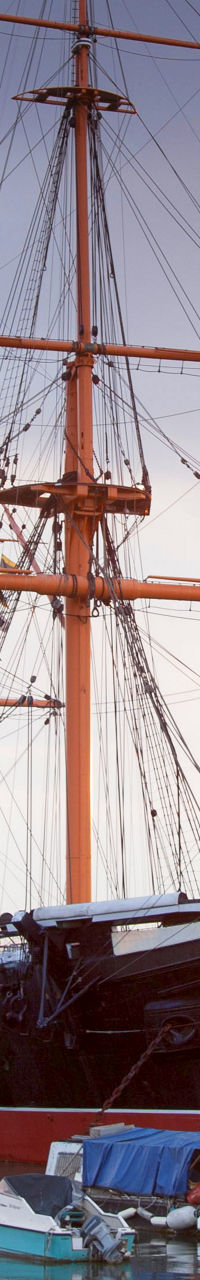 Historic ship docked at sunset harbor