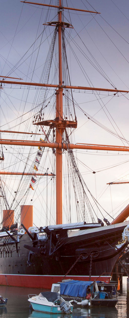 Historic ship docked at sunset harbor