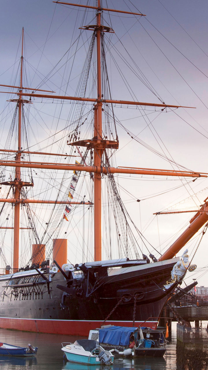 Historic ship docked at sunset harbor