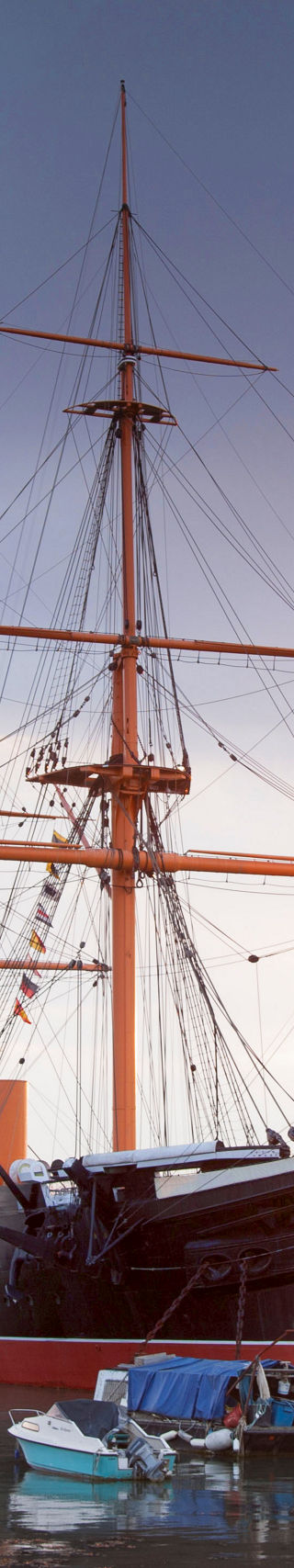 Historic ship docked at sunset harbor