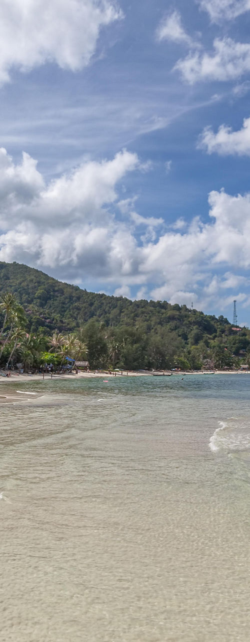 Tropical beach with clear water and boats