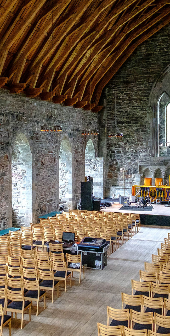 Historic stone hall with wooden vaulted ceiling