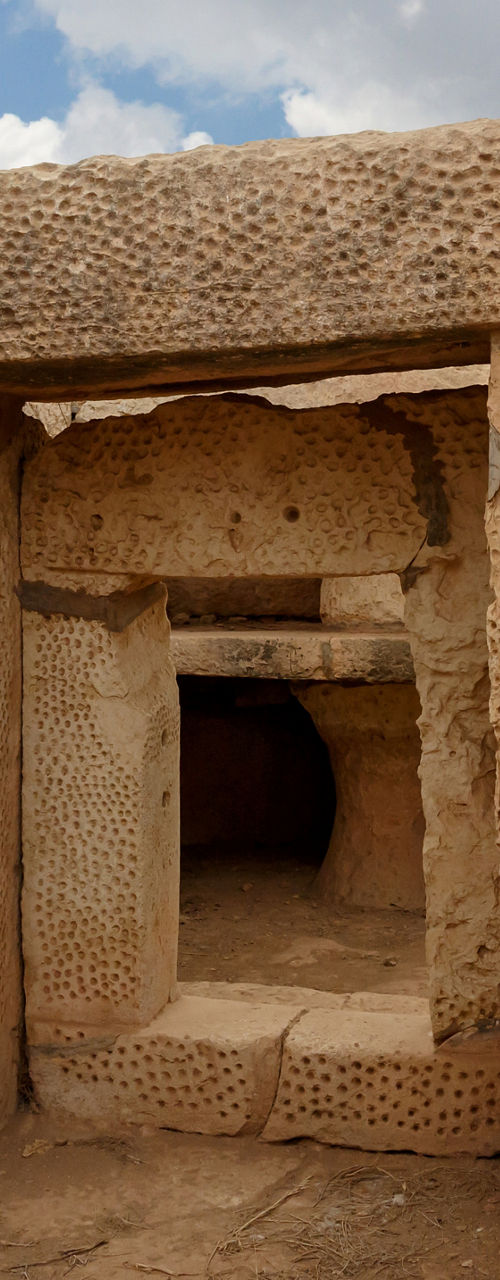 Ancient Megalithic Stone Structure Under Cloudy Sky