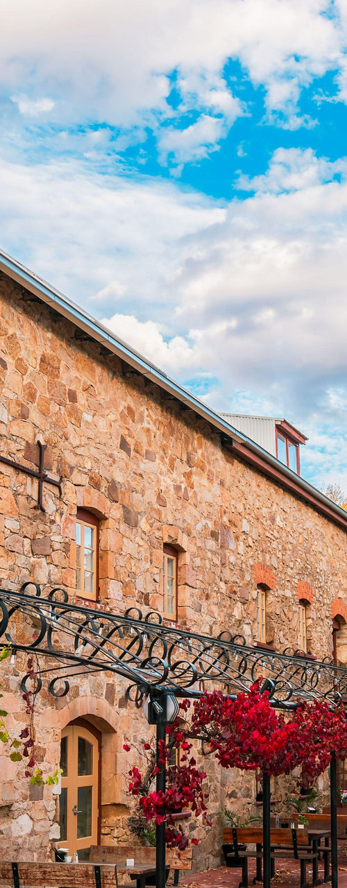 Historic stone building on vibrant street