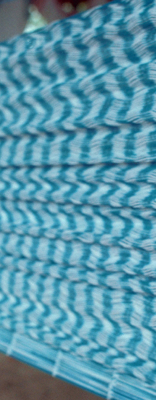 Traditional handloom weaving with blue and white threads
