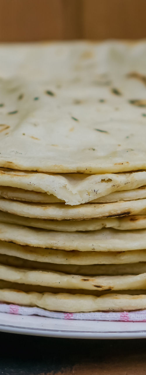 Stack of flatbreads on wooden table