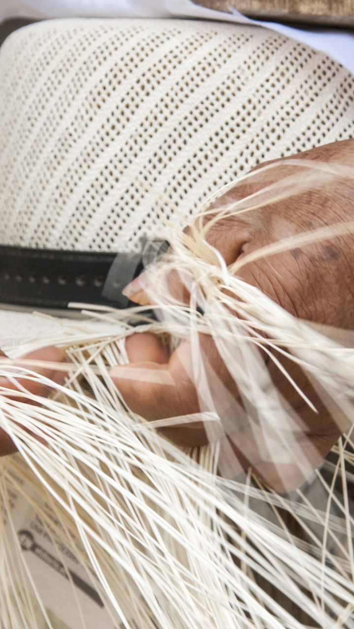 Hand-weaving traditional straw hat