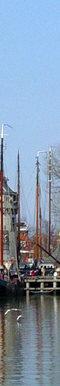 Historic harbor with sailboats and tower