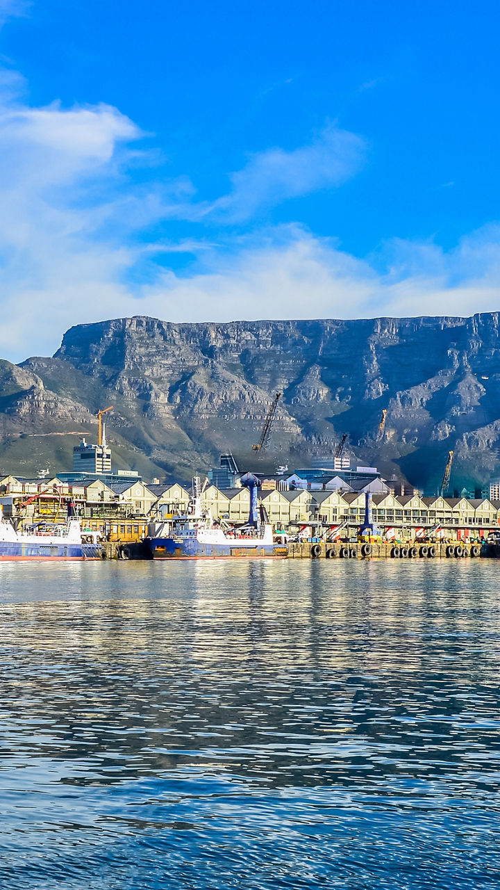 Harbor waterfront with mountain backdrop at sunrise