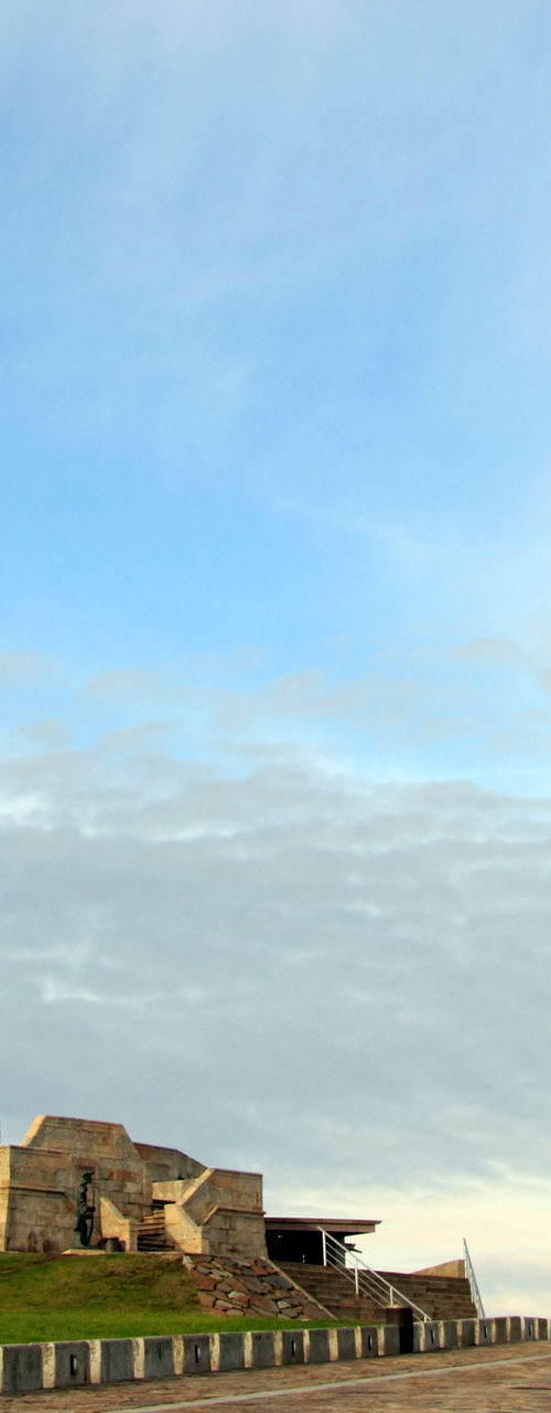 Historic lighthouse under blue sky