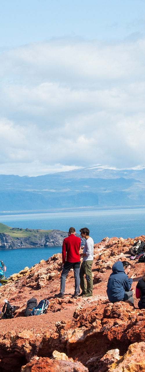Group hiking on coastal cliffside trail