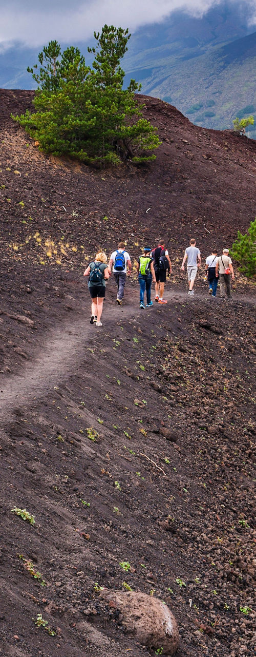 Group hiking on volcanic terrain