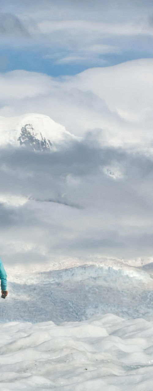 Hikers trekking across snowy glacier landscape