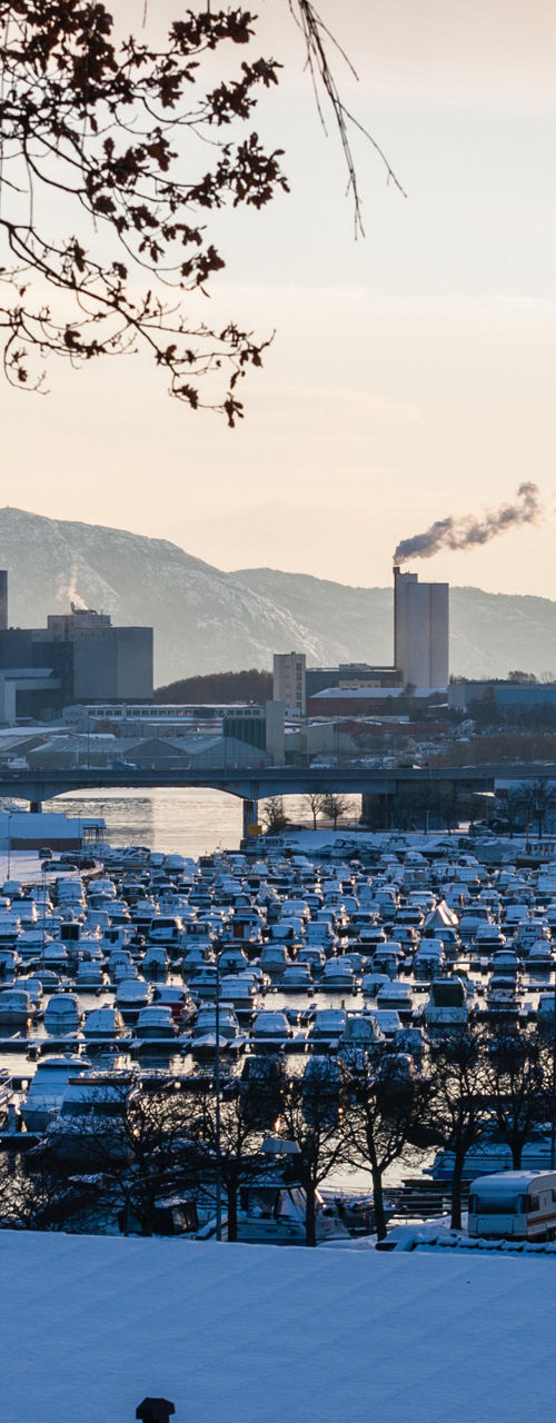 Snowy marina with mountain backdrop