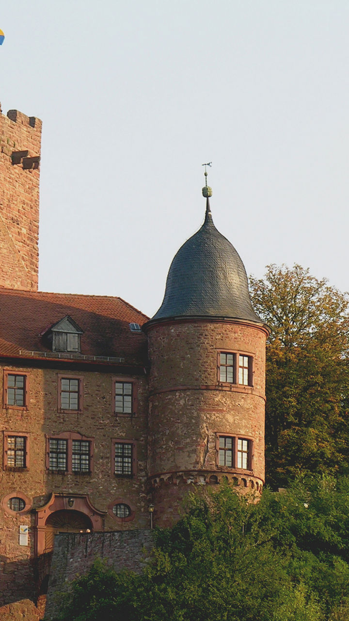 Historic castle surrounded by lush greenery