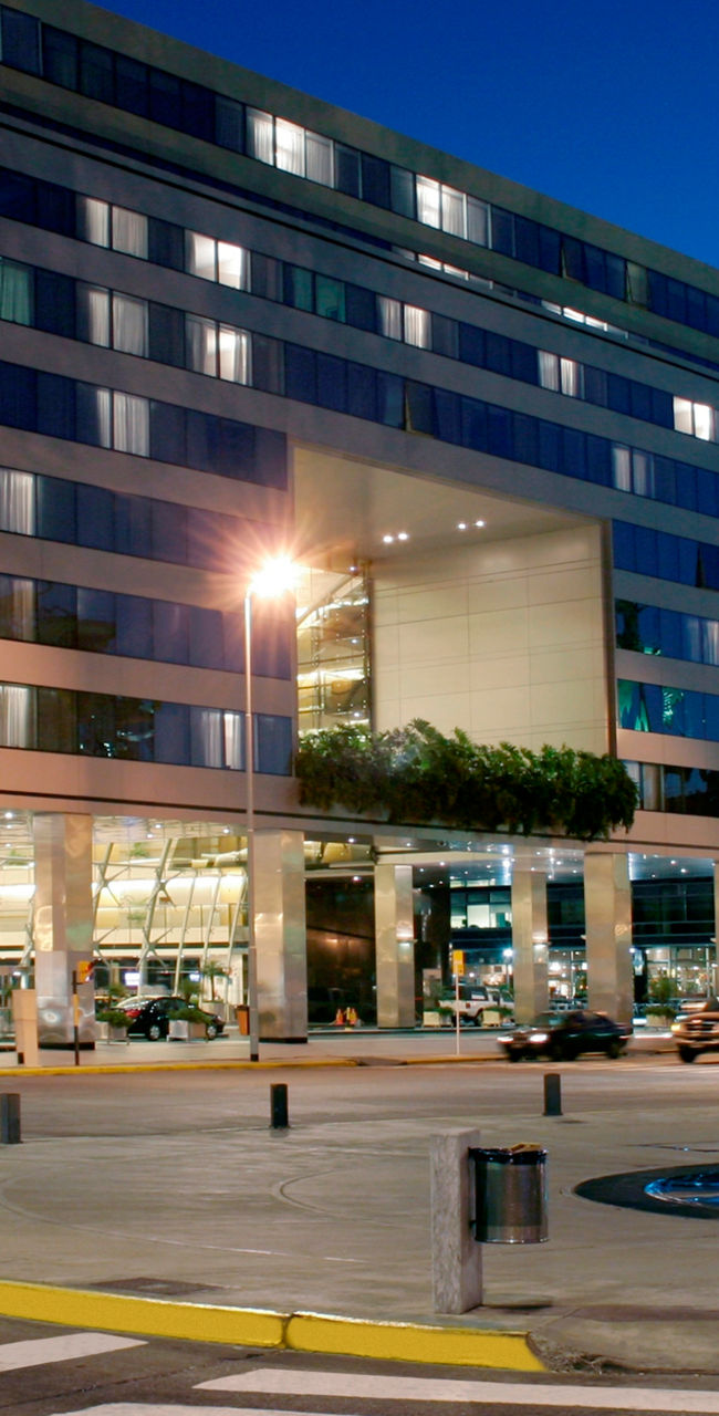 Hilton hotel exterior with fountain at night