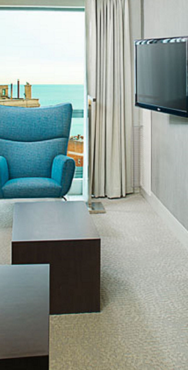 Modern hotel suite with city and ocean views