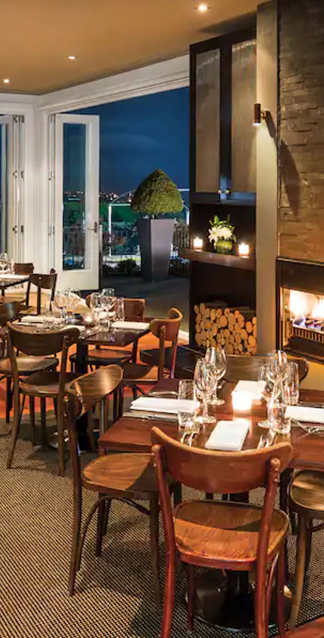 Cozy Restaurant with Fireplace and Night View