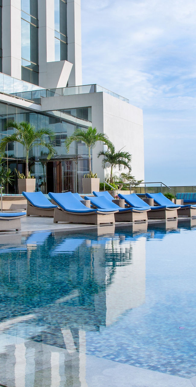 Luxury rooftop pool with blue loungers