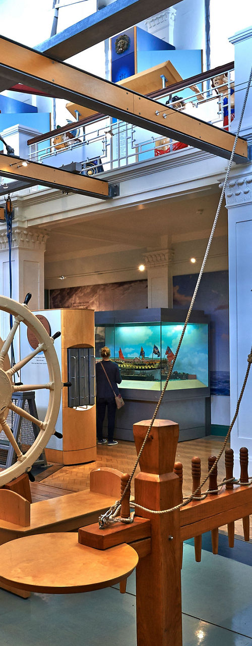 Maritime museum exhibit with ship wheel