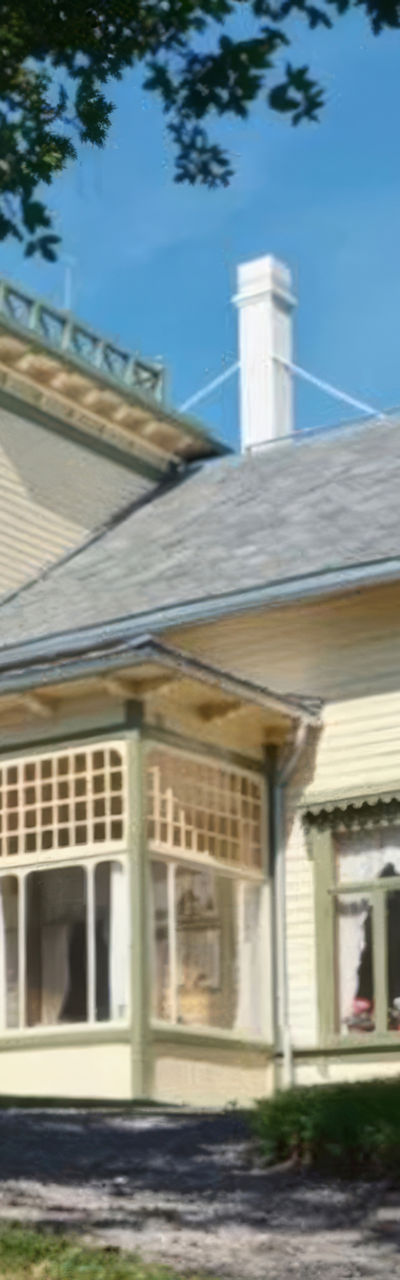 Victorian-style house in lush garden setting