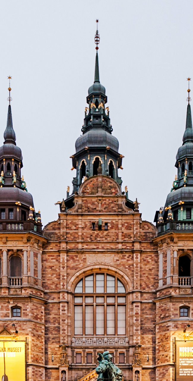 Historic museum building with statue at dusk