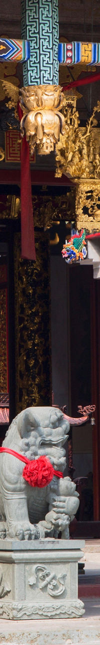 Woman entering ornate Chinese temple