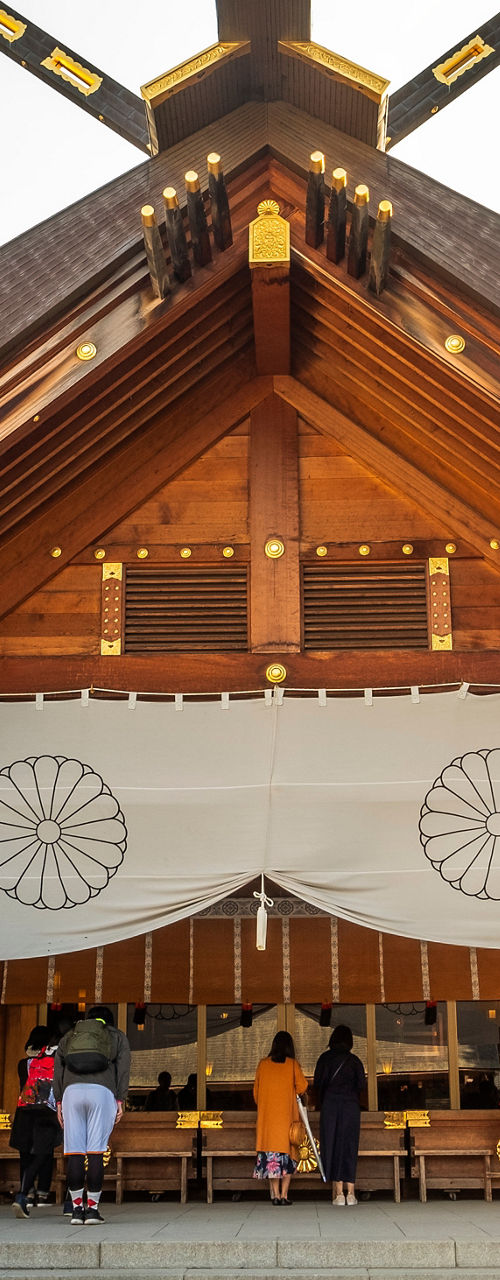 Traditional Japanese shrine with visitors